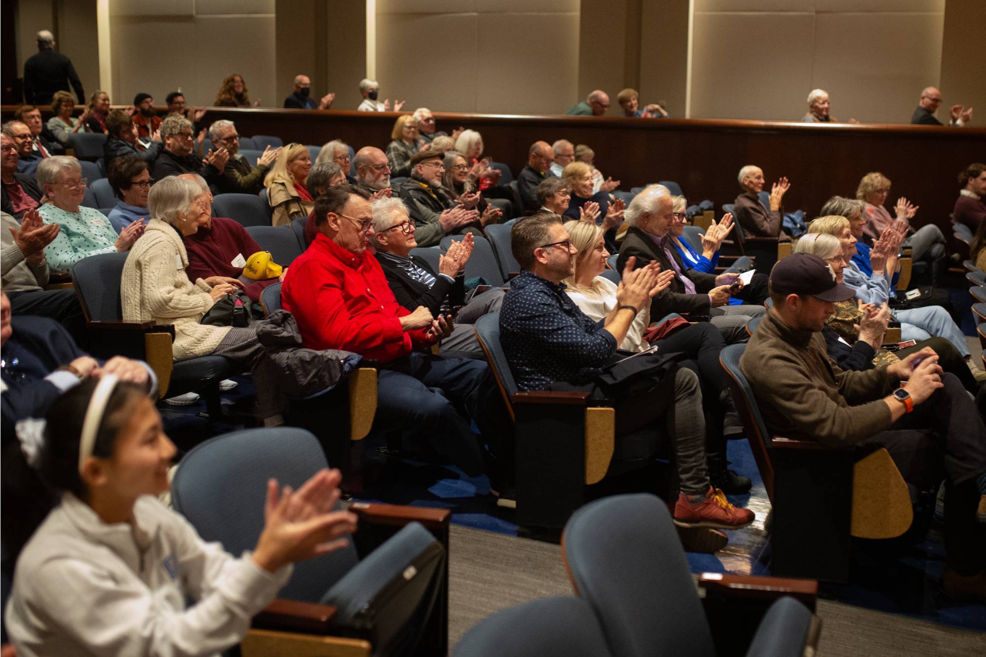 two people sitting on stage